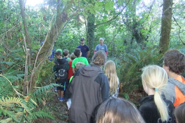 Gold Beach fourth graders are led on a hike, led by high school students and Jim.